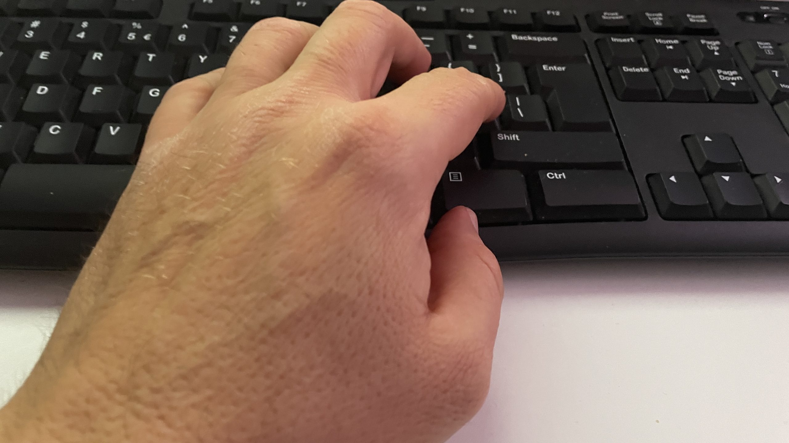 Hand typing on keyboard - Hello World Blog Post